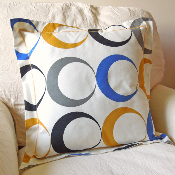 Circles Cushion, Handmade in a Cotton Blue and Gold Eclipse Print with Satin Stitch embroidery, inch 21 inch, x 53 cm